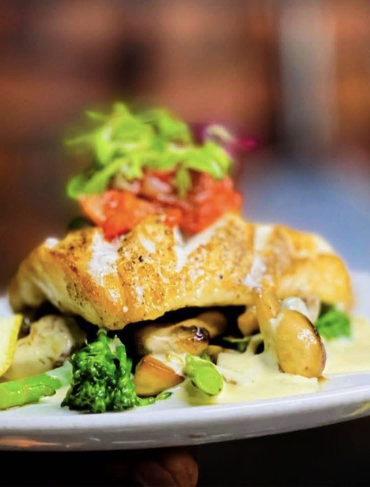Pan-seared fish with vegetables and creamy sauce